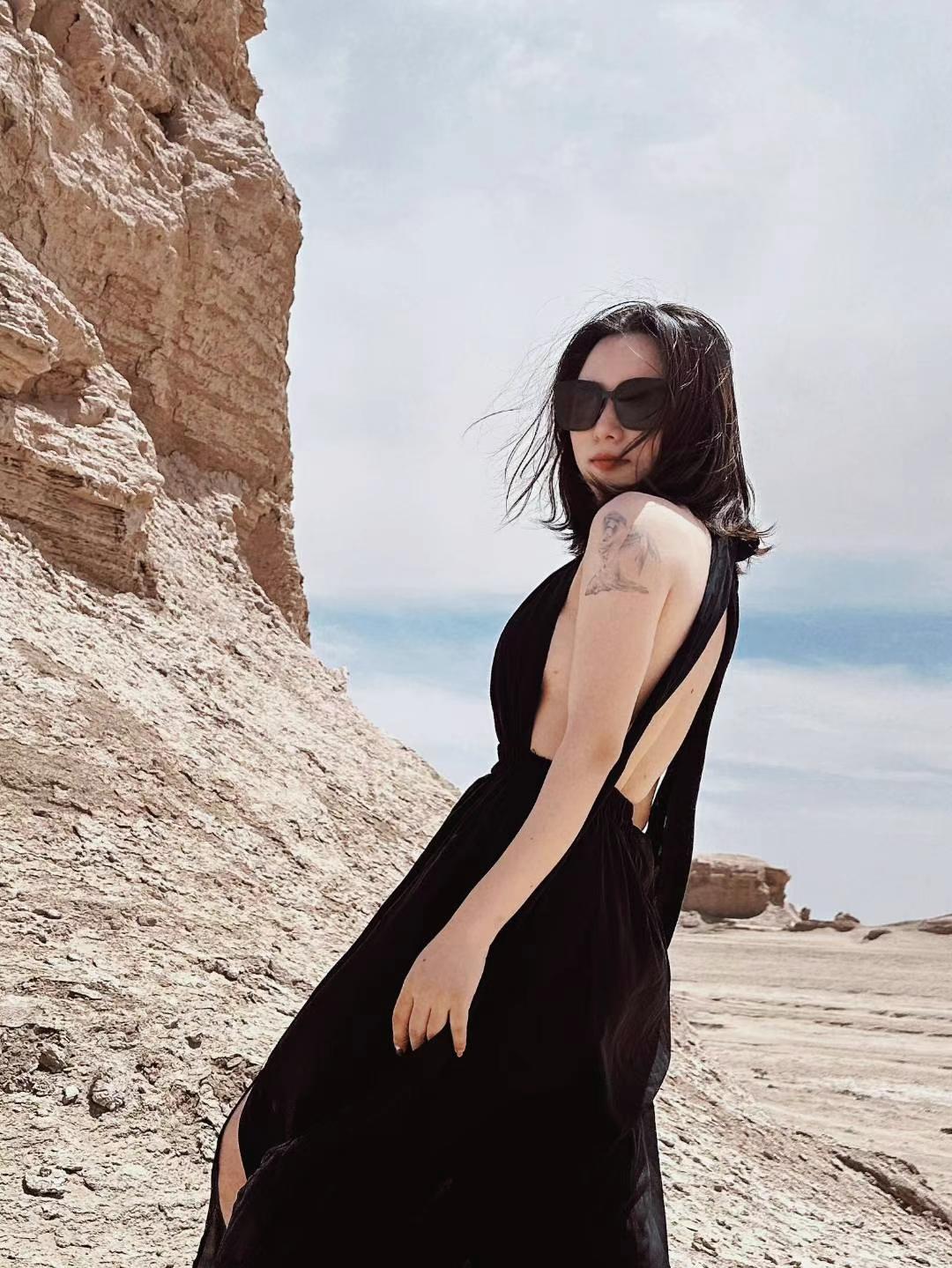 Cliff edge in a black dress